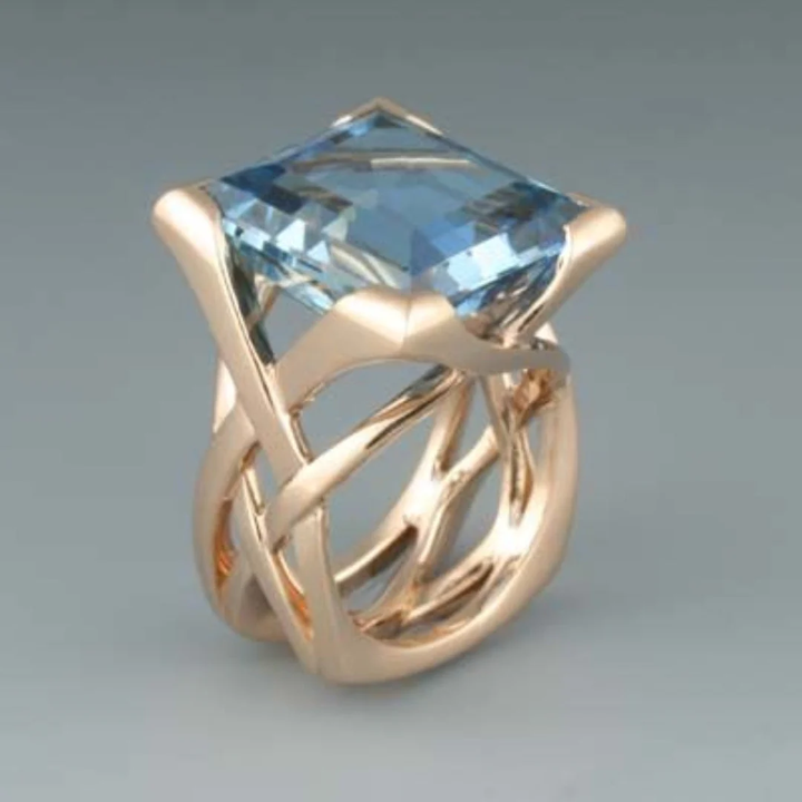 Bague en or rose vintage avec zircones bleues élégantes